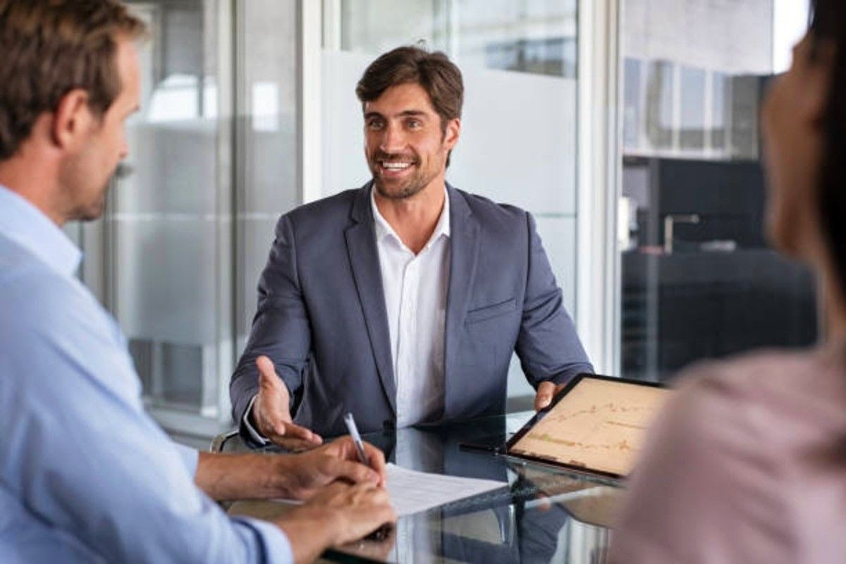 a team having a meeting together with all smiles while showing increase in graph